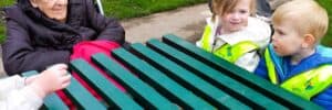 Kids and nursing home patients together on an outdoor excursion