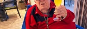 Olea Care Group resident enjoying a drink