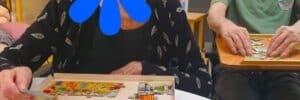 Nursing home patients doing a puzzle