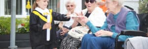 Diploma handed over by a child at Olea Care Group Nursing Hoem Hazel Grove