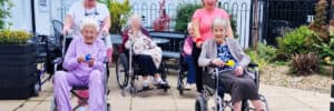 Olea Care Group Residents having a stroll with nurses