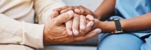 Nurse holding hand of an elerdly man